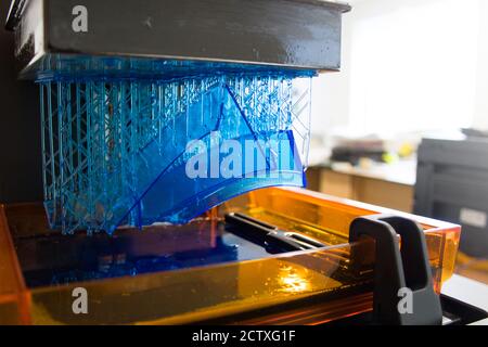 3D printing process. Modern 3D print technology. Working 3d printer machine printing a detail. Close-up. Stock Photo