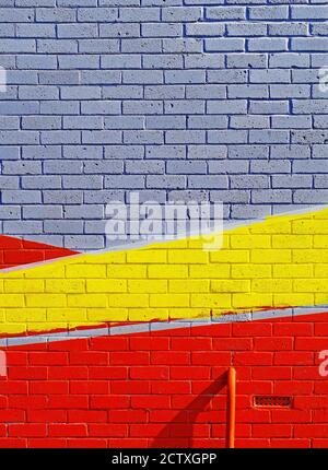 Abstract painted brick wall with directional red yellow with white or grey Stock Photo