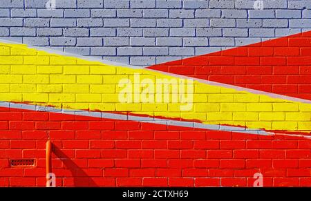 Abstract painted brick wall with directional red yellow with white or grey Stock Photo