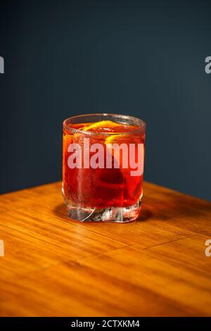 Negroni Cocktail. Gin, Campari and Martini Rosso. Cocktail on wooden bar. Stock Photo