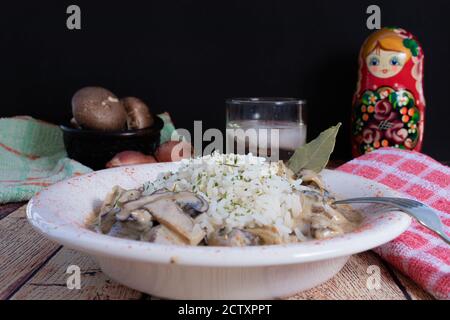 Beef stroganoff with mushrooms in a bowl on rustic background. Stock Photo