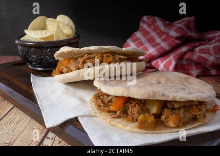Barbeque Pulled Pork Sandwich with BBQ Sauce on pita bread and Fries Stock Photo