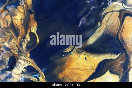Manufacturing a paint composite color. Mixing acrylic paint in different colors. Marbling process Stock Photo