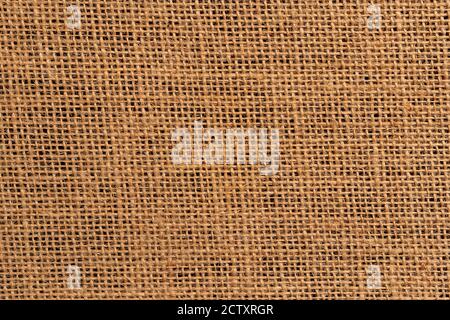 Burlap background close-up on a black background. Dark base. Braided sackcloth material Stock Photo