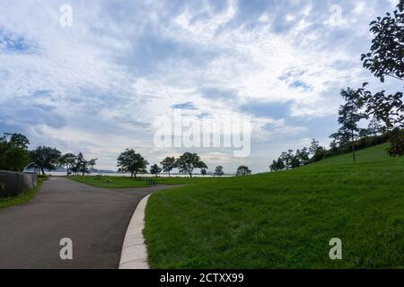 An empty road with trees and bushes on the side. Left and ride curve Stock Photo