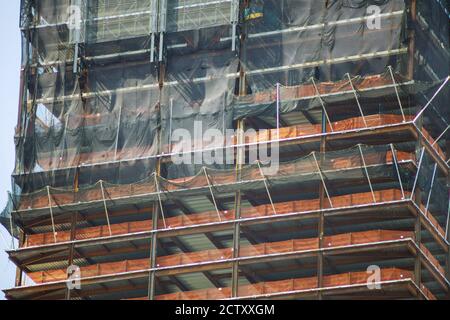 Modern building under construction with below of multi level commercial construction work site building close up Stock Photo