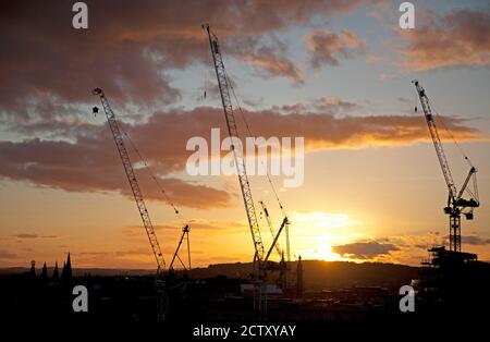 Edinburgh city centre, Scotland, UK. 25 September 2020. Sunset viewed over the the city from Calton Hill, temperature 11 degrees with a slight breeze. Pictured a silhouette of the cranes which are helping construct the new St James Quarter development. Stock Photo