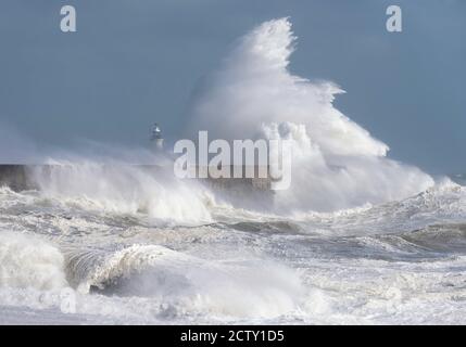 Storm waves breaking over the harbour arm and lighthouse at Newhaven, East Sussex, UK Stock Photo