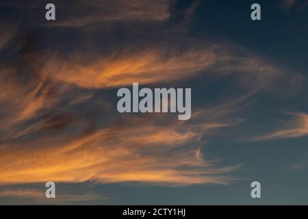 Sunset colorful epic colorful golden clouds on blue dark vivid sky. Magic dusk epic cloudscape Stock Photo