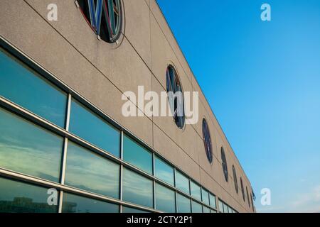 A Tan Building With a Large Window Reflecting the Sunset Sky Stock ...