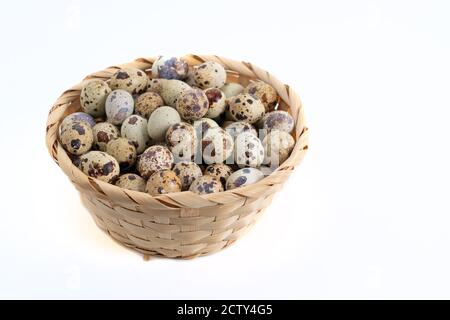 quail eggs inside the basket on white background Stock Photo