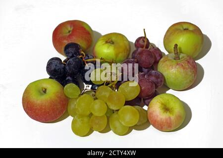 Grapes of three colors with apples close-up on white background Stock Photo