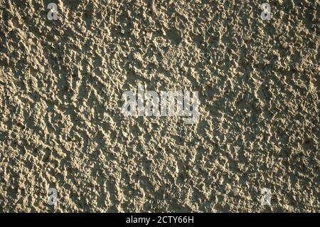 Grainy background,  light yellow wall surface texture shot on a sunny day, hard shadows Stock Photo
