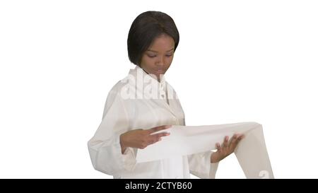 Smiling african american female doctor reading cardiogram on whi Stock Photo