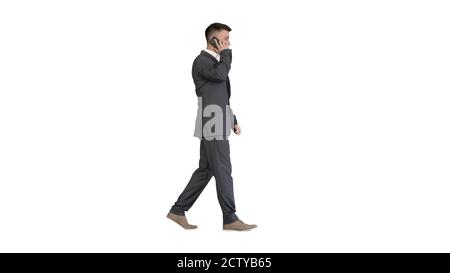 Businessman walking and talking on mobile phone on white backgro Stock Photo