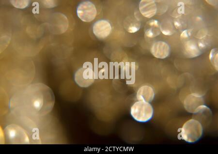 Shiny abstract background with festive defocused lights, golden bokeh. Christmas or New Year holiday concept. Stock Photo