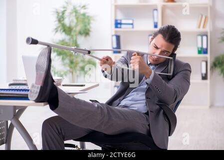 Young employee after accident at workplace Stock Photo