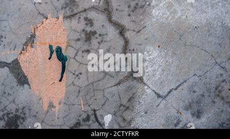 Cracked concrete texture with splash of paint Stock Photo
