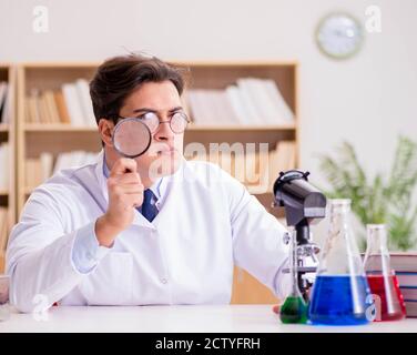 The mad crazy scientist doctor doing experiments in a laboratory Stock Photo