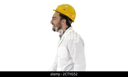 Smiling construction engineer catching a cap and putting it on o Stock Photo