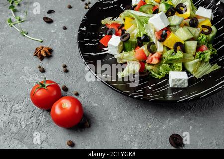 Greek Salad with Cucumeber, Kalamata Olives, Feta Cheese, Juicy Cherry Tomatoes and Fresh Basil. Concept for a tasty and healthy vegetarian meal Stock Photo