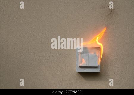 On fire switch electric shock on concrete wall Stock Photo
