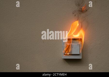 On fire switch electric shock on concrete wall Stock Photo