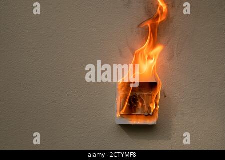 On fire switch electric shock on concrete wall Stock Photo