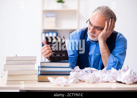 Old male author writing the screenplay Stock Photo