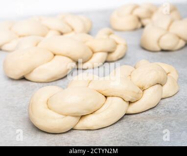 Multiple yeast dough braided in small  buns. Authentic homemade Swiss butter bread recipe called Zopf or Butterzopf. Braided small bread loafs.. Stock Photo