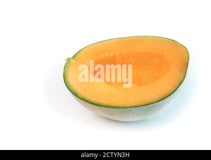 Cantaloupe melon cut in half with seeds scooped out. Also known as rockmelon, sweet melon or spanspek (Cucumis melo). Orange sweet flesh, netted rind. Stock Photo