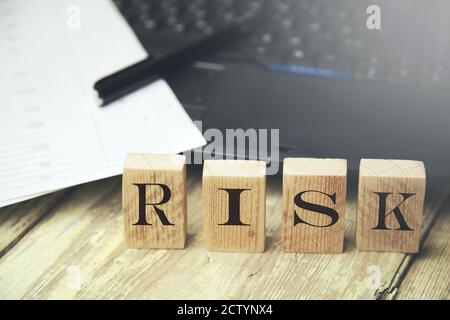 Risk written on a wooden cube in a office desk Stock Photo