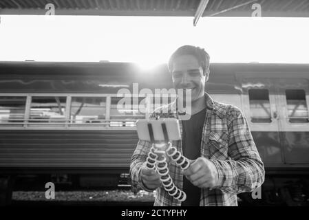 Portrait of handsome Persian tourist man at the railway station Stock Photo