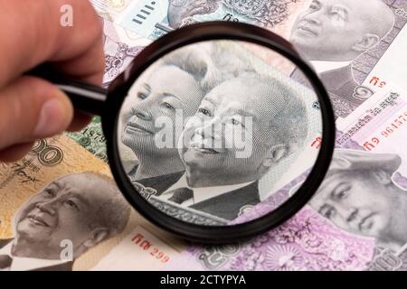 Cambodian riel in a magnifying glass a business background Stock Photo