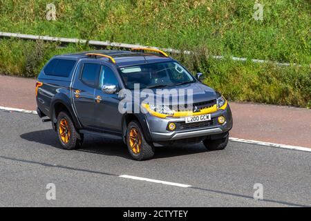 2019 yellow grey MITSUBISHI L200 SPECIAL EDITIONS Double Cab DI-D 181 Barbarian SVP II 4WD ; Vehicular traffic moving vehicles, cars, vehicle driving on UK roads, motors, motoring on the M6 motorway highway road network. Stock Photo