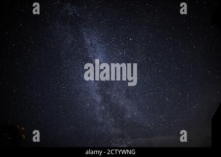 in the night sky you can see the milky way and the traces of satellites Stock Photo