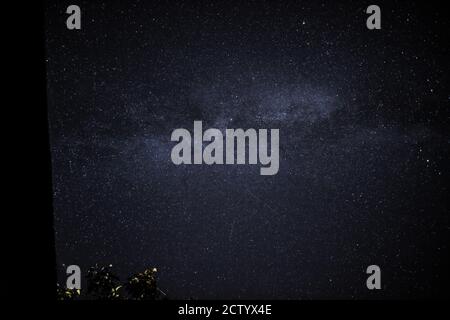 in the night sky you can see the milky way and the traces of satellites Stock Photo