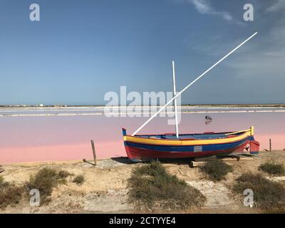 The colorful boat in front of the also colorful salt marsh of the salines in Gruissan, south france Stock Photo