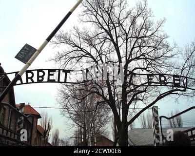 Entrance gate to the Auschwitz-Birkenau concentration camp, featuring the infamous sign 'Arbeit Macht Frei' ('Work Sets You Free'). A powerful histori Stock Photo