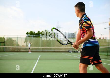 Athletic tennis players, training on outdoor court Stock Photo