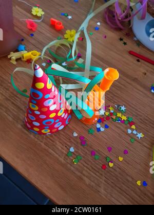Any Colored confetti and party hat on a wooden table Stock Photo