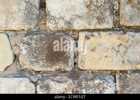 Background - Old textured brick wall overgrown with moss Stock Photo