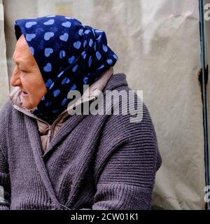 Elderly Homeless Woman Sitting Alone Highlighting The UK Housing Crisis Stock Photo