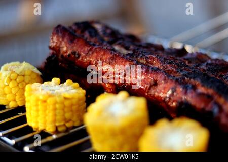 Grilling barbecue pork ribs and corn - selective focus , close up Stock Photo
