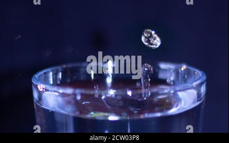 splash of drops in a glass of water Stock Photo
