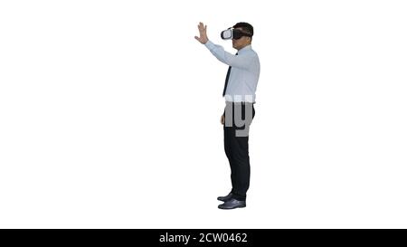 Young businessman using vr headset on white background. Stock Photo