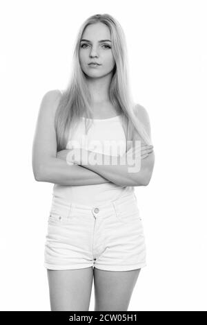 Studio shot of young beautiful teenage girl standing with arms crossed Stock Photo