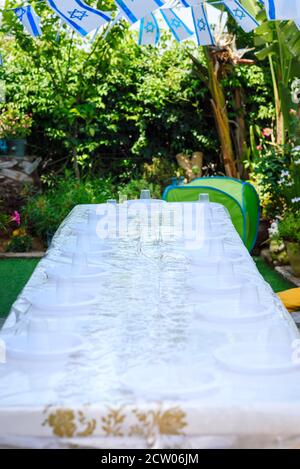 Table setting with plastic ware for summer picnic outdoor. Stock Photo