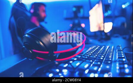 Professional computer mouse for video games and cyber sports on background of monitor, neon color Stock Photo