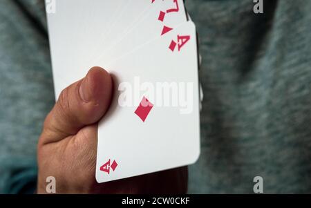 A deck of playing cards in hand, shuffling the deck, gambling. Stock Photo